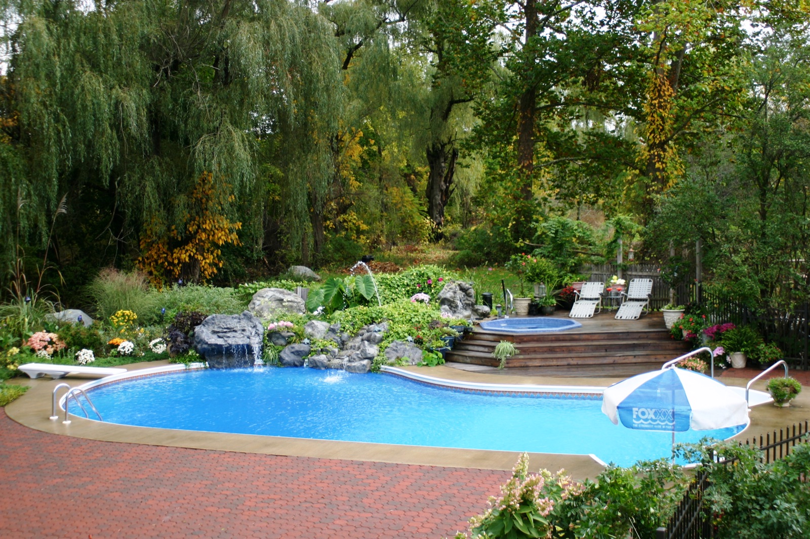 A curved kidney-shaped pool built for backyard fun